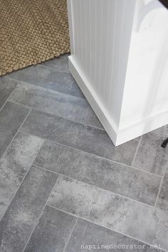 a tile floor in a bathroom next to a toilet