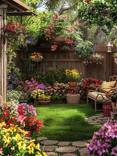 a garden filled with lots of flowers next to a wooden fence on top of a lush green field