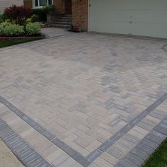 a brick driveway in front of a house