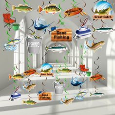 an image of some fish hanging from the ceiling in front of a wall with words on it