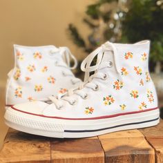 Why blend in when you can stand out from the crowd? These custom trainers take the classic Converse high tops and transform them into unique pieces of wearable art. I only purchase 100% genuine shoes from the official converse website. I then use high quality embroidery thread to embellish the converse with a dainty flower design. Sizes are in standard woman UK sizes. **Because each pair of trainers are made to order I do not provide refunds if the shoes do not fit, so be sure that you have orde Chuck Shoes, Converse Colors, Converse Embroidery, High Tops Shoes, Classic Converse, Embroidered Converse, Converse Custom, Custom Converse, Embroidery Shoes