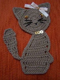 a crocheted cat with a bow on its head