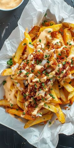 french fries covered in sauce and garnished with parmesan