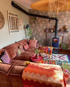 a living room with couches, rugs and pictures on the wall above them