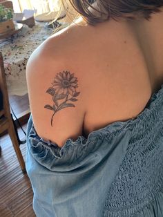 a woman with a sunflower tattoo on her shoulder