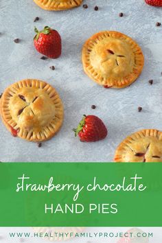 strawberry chocolate hand pies on a baking sheet with strawberries in the background and text overlay