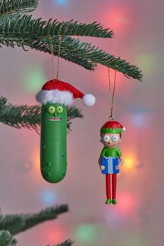 an ornament hanging from a christmas tree with a pickle and santa hat on it