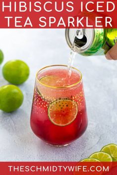 a person pouring a drink into a glass with limes around it and the words hibiscus iced tea sparkler