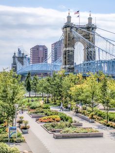 the bridge is very tall and has many flowers in it's garden beds on both sides