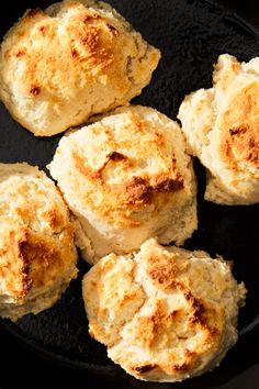 four biscuits in a skillet on top of a table