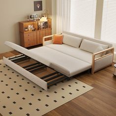 a white couch sitting on top of a wooden floor