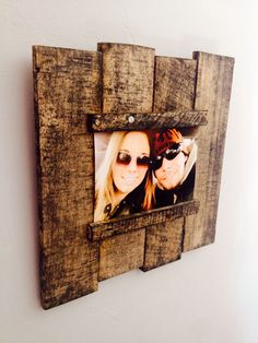 an old wooden frame with two women wearing sunglasses