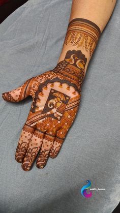 a person's hand with henna tattoos on it