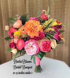 the bridal bouquet is displayed in front of a wooden background with text that reads, dahlias blooms, bride bouquet, 12 - 19 inches wide