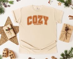 Stay stylish and comfortable this autumn with our "Cozy Season" t-shirt, perfect for embracing the warmth and laid-back vibes of fall. Made from high-quality cotton, this tee is soft, breathable, and ideal for layering or wearing on its own. Whether you're enjoying pumpkin spice lattes or a cozy night in, this t-shirt is the perfect companion for all your fall activities. --- How to Order --- Step 1: Select your preferred T-Shirt size Step 2: Select your preferred T-Shirt color Step 3: Add your personalization (optional) Step 4: Choose your shipping preference Step 5: We prepare and ship your order quickly! Step 6: Your order arrives! Don't like it? Always reach out to us. Your satisfaction is our priority! --- Key Features --- - Premium quality, printed in the USA - Soft, comfortable Comf Cozy Cotton T-shirt For Loungewear, Comfy Cotton Tops With Graphic Print, Cozy Cotton T-shirt With Graphic Print, Cozy Letter Print T-shirt For Loungewear, Cozy Crew Neck T-shirt With Letter Print, Cozy Relaxed Fit T-shirt With Graphic Print, Cozy T-shirt With Letter Print For Loungewear, Comfortable Fall Loungewear T-shirt, Cozy Graphic Print T-shirt For Fall