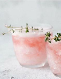 two glasses filled with watermelon and garnished with herbs