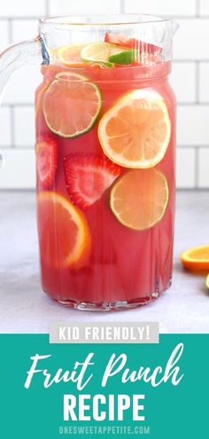 a pitcher filled with fruit punch and sliced oranges