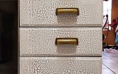 three drawers with gold handles on each drawer