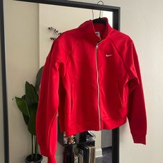 Brand New Super Cute Waist Length Women’s Nike Jacket In Size Medium. Sporty University Red Outerwear For Fall, Sporty University Red Track Jacket, Red Athleisure Outerwear For Winter, Nike Red Sporty Outerwear, Red Athleisure Outerwear With Pockets, Red Athleisure Outerwear For Spring, Red Athleisure Outerwear For Fall, Red Spring Athleisure Outerwear, Red Athleisure Track Jacket For Fall