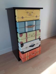 four suitcases stacked on top of each other in front of a wall and floor