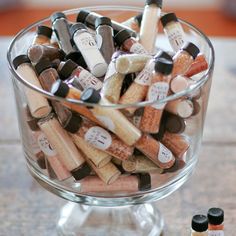 a glass bowl filled with lots of different colored confections