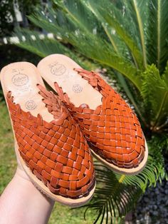 COLOR: BRICKUPPER: LEATHERSOLE: CREPE Handmade huaraches from Michoacán, Mexico. Made with 100% leather. SIZING *Please refer to sizing chart*If you wear a half-size shoe we recommend sizing down (ex: Your shoe size is 7.5, size down to size 7)If you have a wide foot, For example, your shoe size is 7.5 then size up for a more comfortable fit. Leather stretches and will mold after a few uses*Please advise since all of our huaraches are handmade with genuine leather minor wrinkles and markings mig Leather Mules With Woven Sole In Natural Color, Natural Leather Mules With Woven Sole, Brown Leather Mules With Woven Sole, Brown Woven Leather Huarache Sandals, Brown Adjustable Round Toe Clogs, Adjustable Brown Mules With Leather Footbed, Casual Summer Clogs With Stitched Sole, Casual Adjustable Closed Toe Mules, Brown Woven Leather Huaraches For Summer