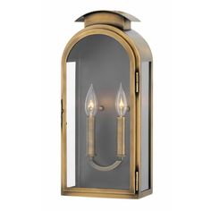 an outdoor wall light with two candles on the front and one candle in the back