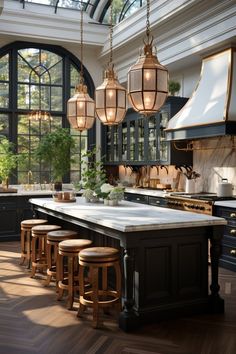 a large kitchen with lots of lights hanging from the ceiling