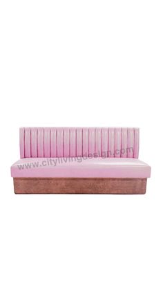 a pink bench sitting on top of a white wall