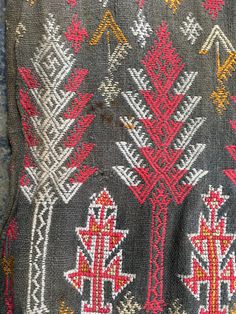 an old sweater with red and yellow designs on it