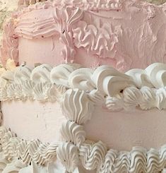 a three layer pink cake with white icing