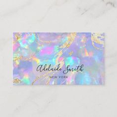 a business card with an iridescent background and gold foil on the bottom corner