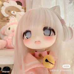 a doll with long white hair and blue eyes sitting next to stuffed animals in a room