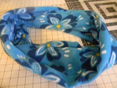 a blue and white flowered headband sitting on top of a tiled floor