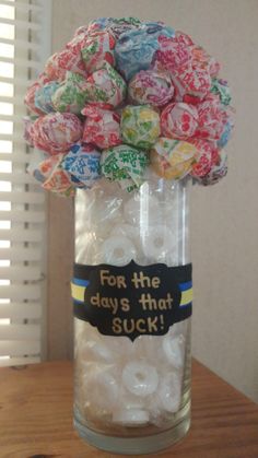 a jar filled with lots of candy sitting on top of a table