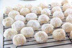 powdered sugar balls are cooling on a rack