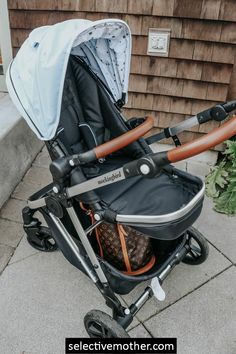 a baby stroller sitting on the sidewalk next to a house