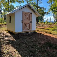 a small shed in the middle of a field