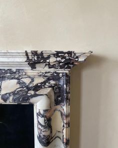 an ornate white and black marble fireplace surround