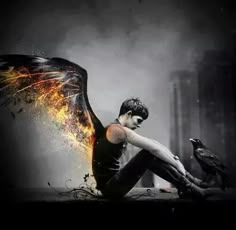 a man sitting on the ground with a bird in his hand and fire coming out of his wings