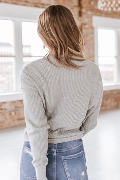 Feel stylish and comfortable in the Emmarie Knit Wrap Top. This versatile top can be worn for any occasion, whether it's a casual day out or a night on the town. Made with soft and breathable fabric, it will keep you feeling great all day long. Elevate your wardrobe with this must-have piece! Soft Knit V-neck Top, Chic Oversized Soft Knit Top, Oversized Soft Knit Chic Top, Winter Ribbed Knit Top For Day Out, Comfortable Gray Stretch Top, Comfortable Stretch Gray Tops, Casual Ribbed Long Sleeve Top For Winter, Cozy Winter Stretch Tops, Chic Cozy Fit Tops For Winter