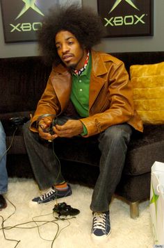 a man with an afro sitting on a couch