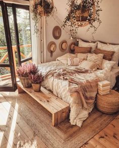 a bed sitting in a bedroom next to a window with plants growing on the wall