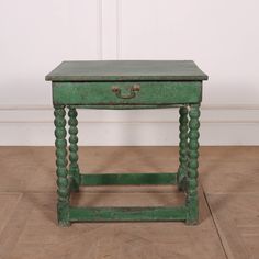 an old green wooden table on the floor