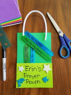 a bag with writing on it sitting next to scissors and other crafting supplies that include crayons