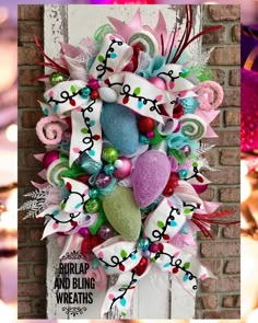 a colorful wreath is hanging on a brick wall and decorated with ribbons, flowers, and hearts