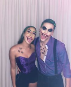 two people dressed up as the joker and catwoman posing for a photo with their mouths open