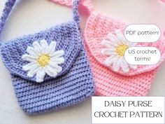 two crocheted purses with flowers on them, one is pink and the other is blue