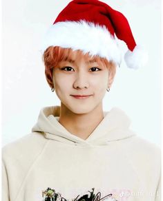 a young man wearing a santa hat on top of his head