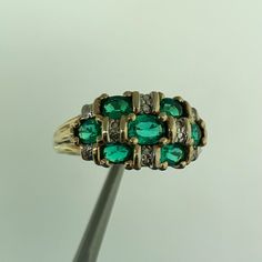 * Designer 14K Yellow Gold Oval Emerald Diamond Accented Dome Cocktail Ring * Ring size: 7.0 * Top of ring measures 3/8" x 5/8" * Height: 1/4" * Band width: 2.08 mm * Seven oval Emeralds measure approximately 4.3 mm x 2.7 mm each * Diamonds measure approximately 1.25 mm each * Ring weight: 3.3 tgw * Marked: 10K * MAKERS MARK * CR3HD163 * Ring can be resized for an additional fee. * Condition: As pictured * G3365    Exported By ExportYourStore :) Green Multi-stone Oval Diamond Ring, Green Oval Multi-stone Diamond Ring, Oval Green Multi-stone Diamond Ring, Classic Multi-stone Oval Cabochon Rings, Oval Multi-stone Cluster Ring For Formal Occasions, Oval Yellow Gold Emerald Ring With Multi-stone, Oval Emerald Ring With Multi-stone Diamond, Oval Yellow Gold Emerald Ring With Multiple Stones, Classic Oval Multi-stone Cluster Ring